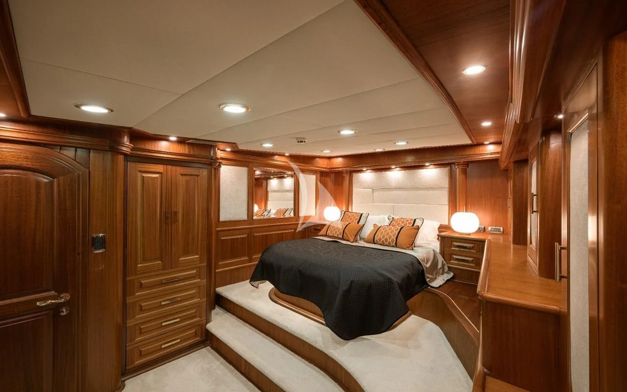 a bedroom with a bed and a closet aboard KAPTAN KADIR Yacht for Sale