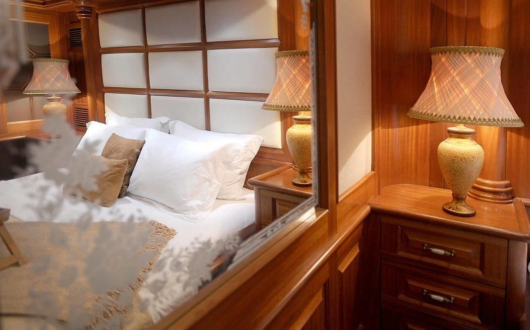 a bed with a lamp and a lamp on it aboard KAPTAN KADIR Yacht for Sale