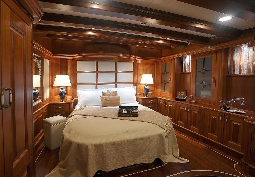 a bedroom with a bed and a desk aboard KAPTAN KADIR Yacht for Sale