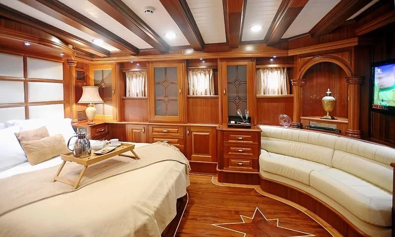 a room with a bed and a television aboard KAPTAN KADIR Yacht for Sale