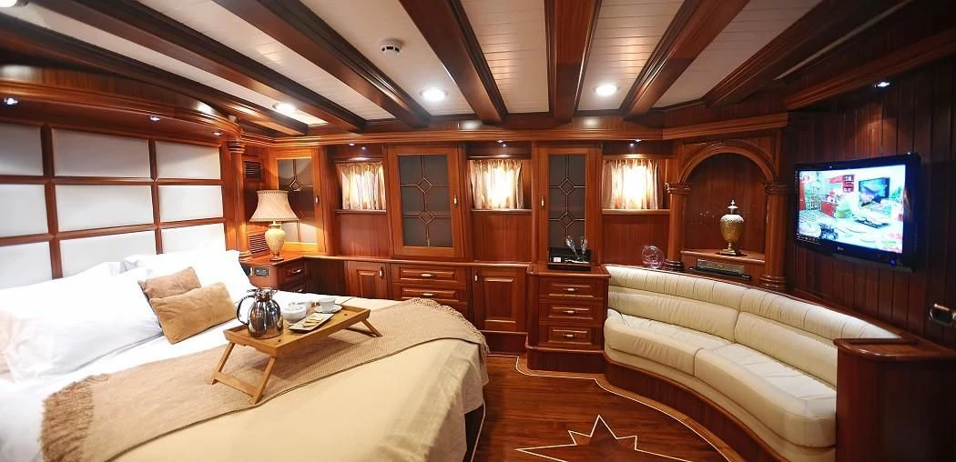 a room with a bed and a television aboard KAPTAN KADIR Yacht for Sale
