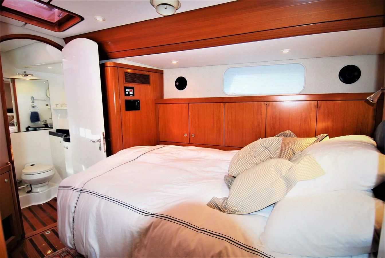 a bed with white sheets aboard LEONORE Yacht for Sale