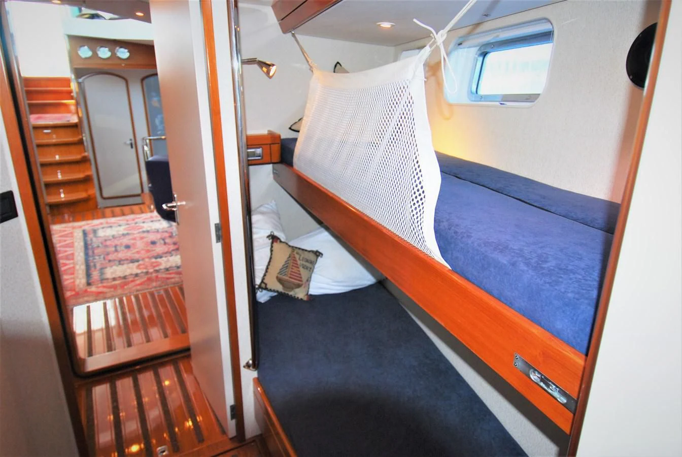 a room with a bed and a door aboard LEONORE Yacht for Sale