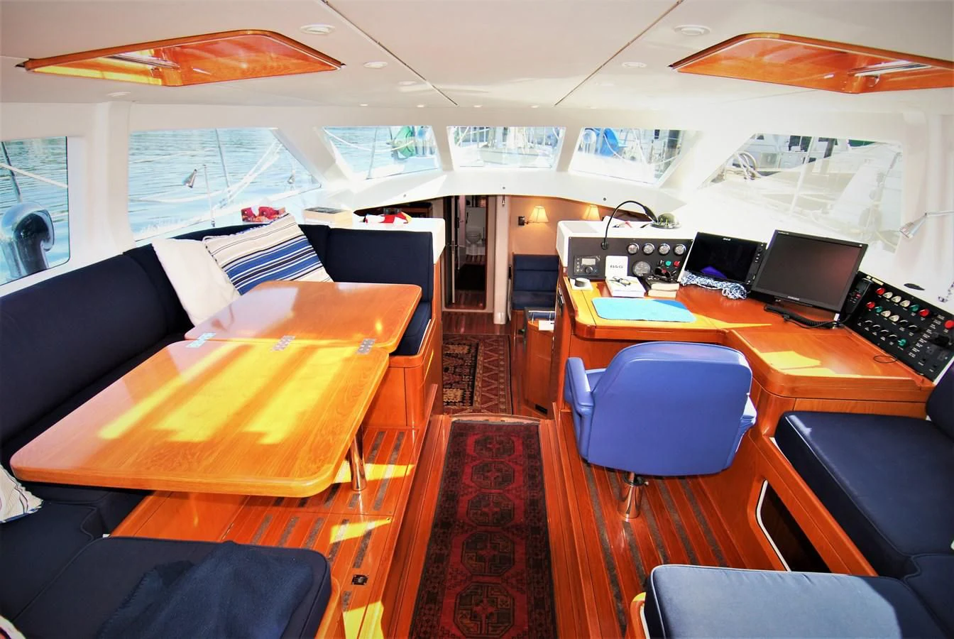 a room with a table and chairs aboard LEONORE Yacht for Sale