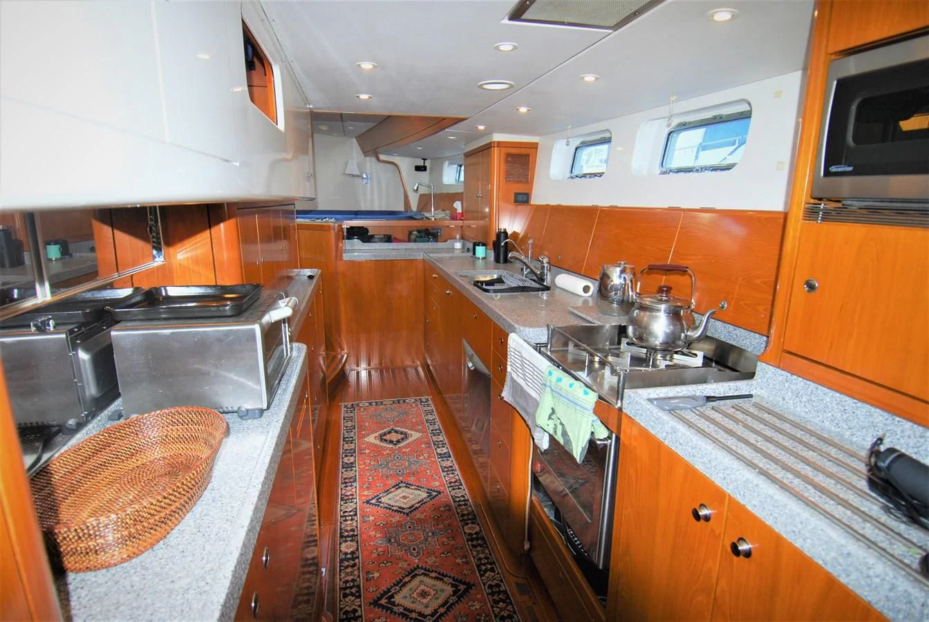 a kitchen with a stove and oven aboard LEONORE Yacht for Sale