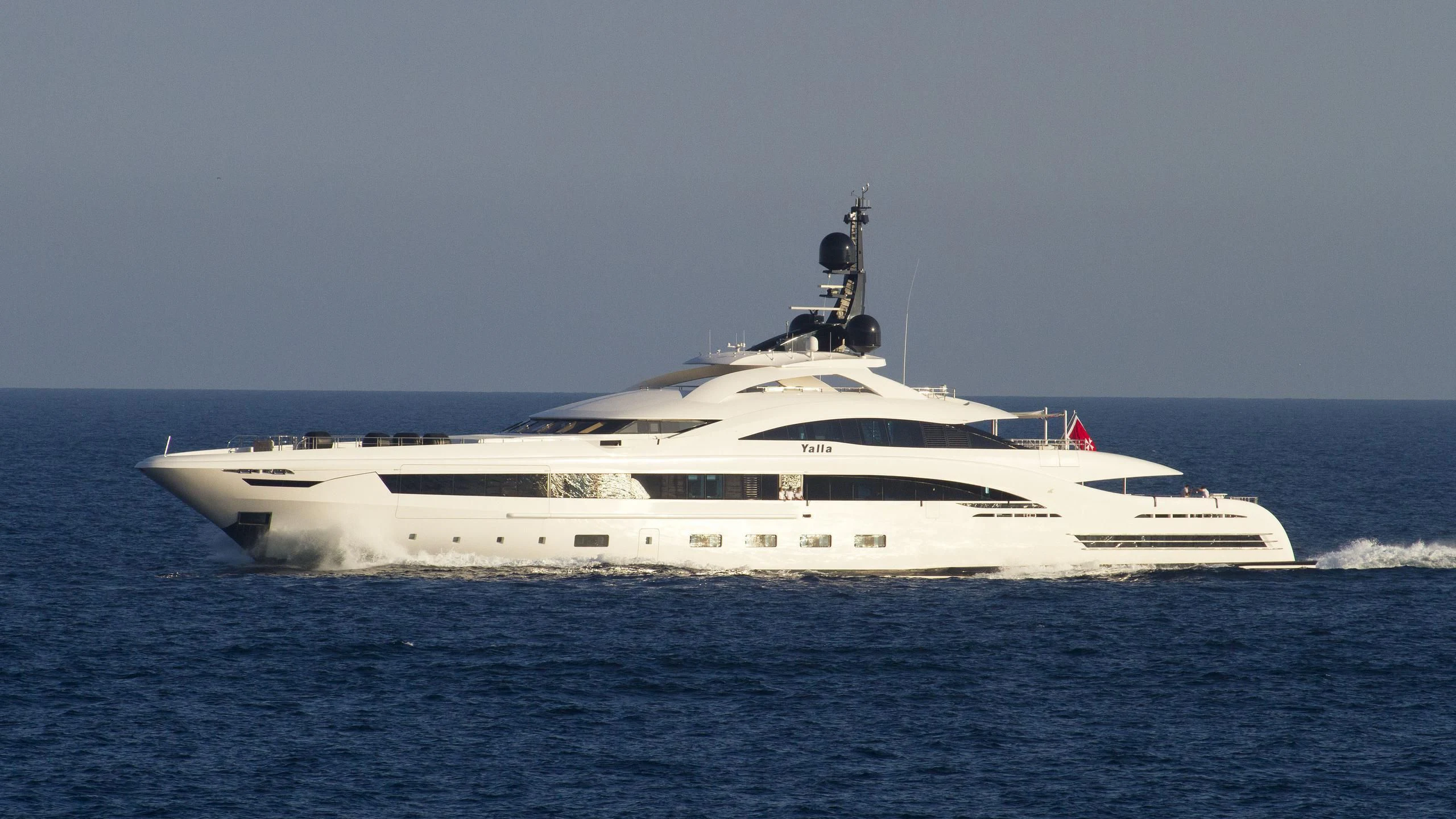 a white yacht on the water aboard YALLA Yacht for Sale
