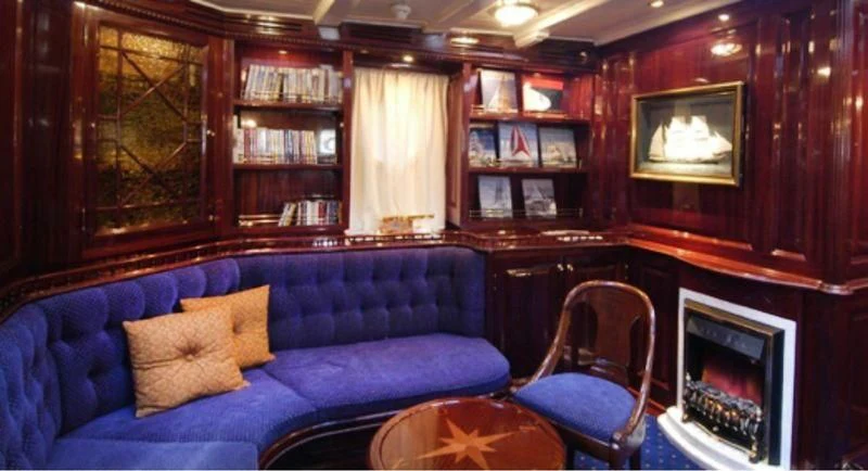 a blue couch in a room aboard DORIANA Yacht for Sale