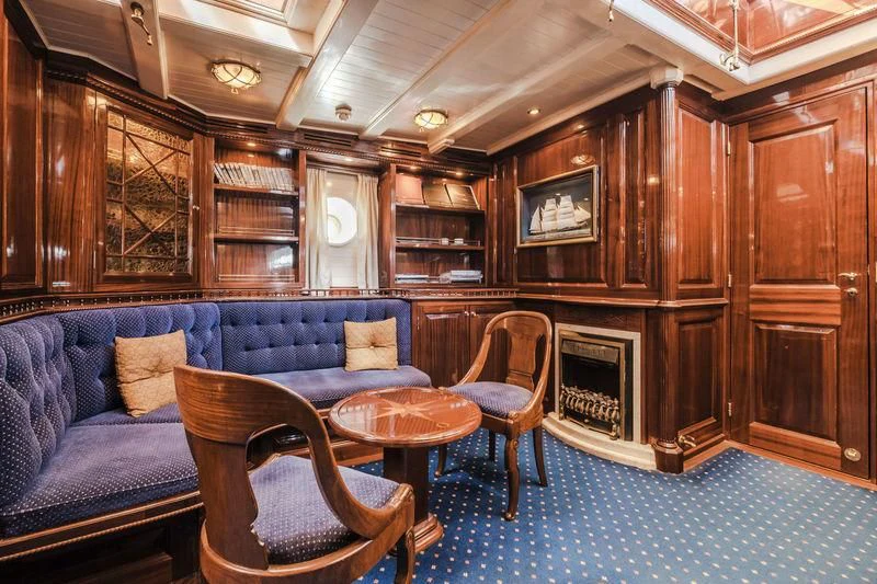 a living room with a couch and a table aboard DORIANA Yacht for Sale