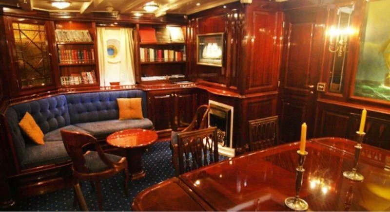 a large room with a couch and a table aboard DORIANA Yacht for Sale