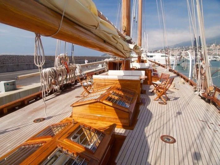 a large sailboat on a deck aboard DORIANA Yacht for Sale