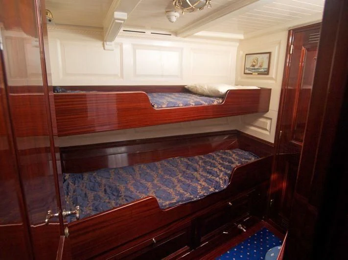 a room with a bed and a mirror aboard DORIANA Yacht for Sale