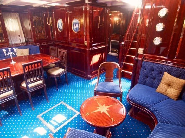 a room with a couch and chairs aboard DORIANA Yacht for Sale