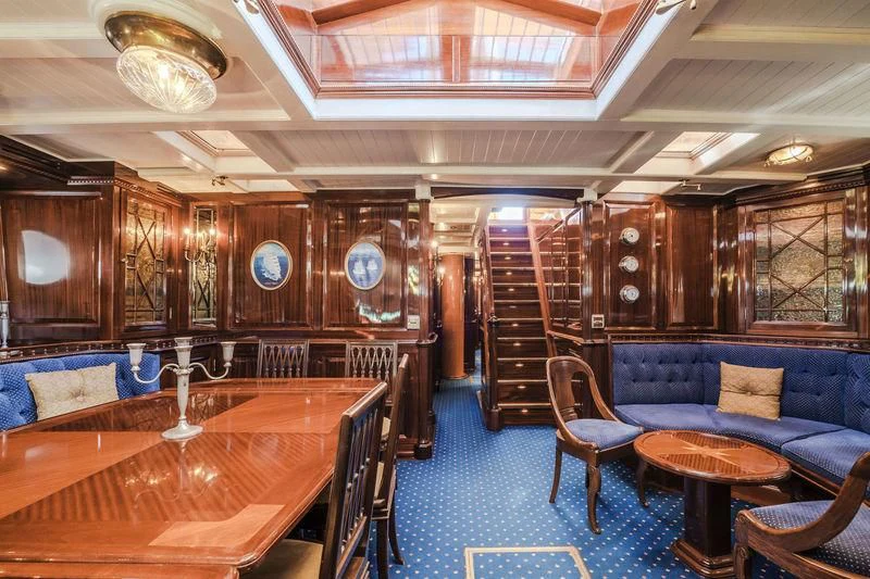 a room with a couch and a table and chairs aboard DORIANA Yacht for Sale