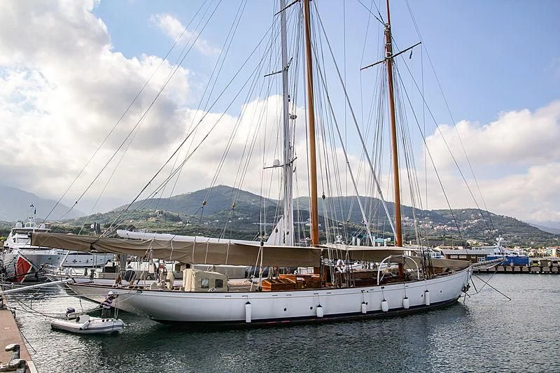 a large white boat in a harbor aboard DORIANA Yacht for Sale