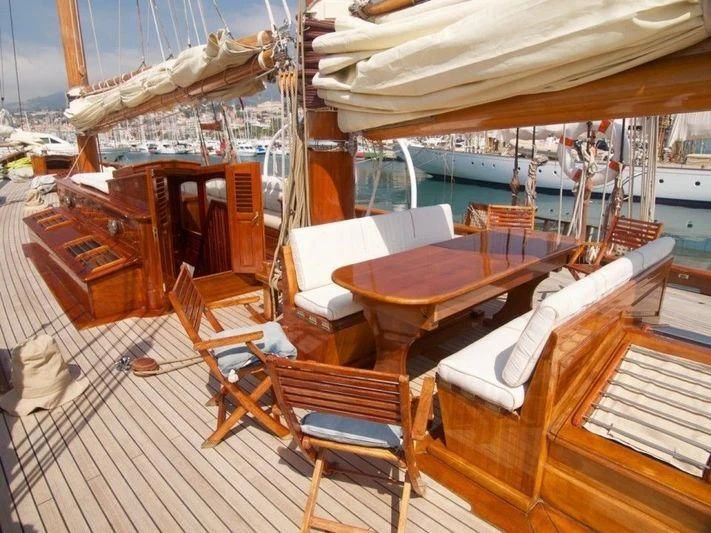 a boat with tables and chairs aboard DORIANA Yacht for Sale