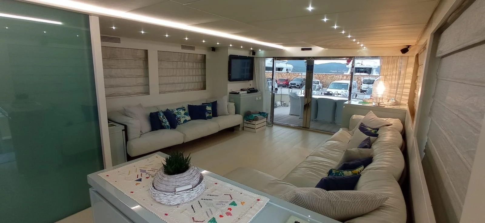 a living room with a large glass door aboard MATHISSE Yacht for Sale