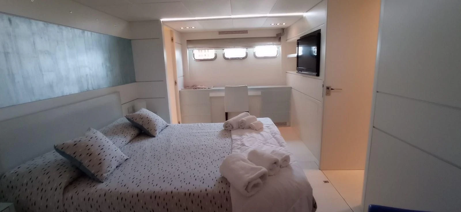 a room with a bed and a television aboard MATHISSE Yacht for Sale