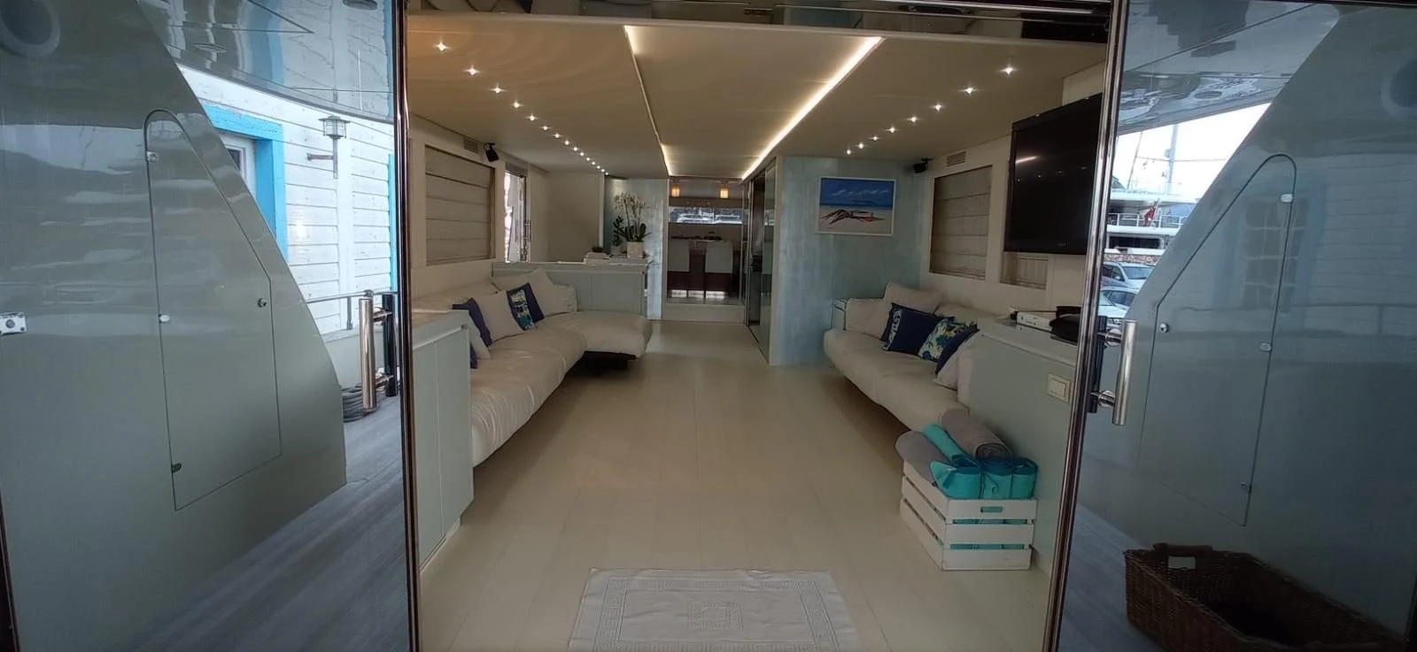 a room with a couch and a television aboard MATHISSE Yacht for Sale