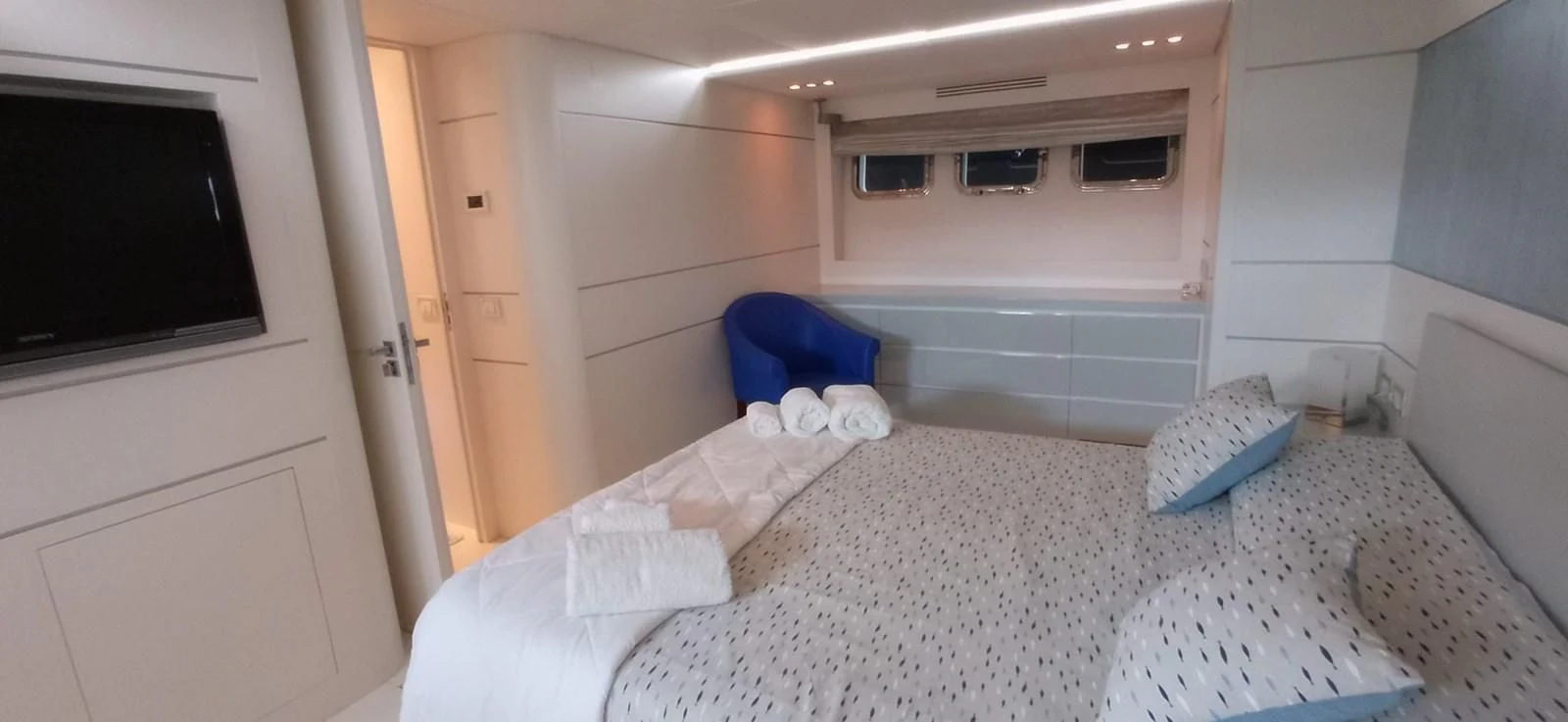a white room with a bed and a window aboard MATHISSE Yacht for Sale