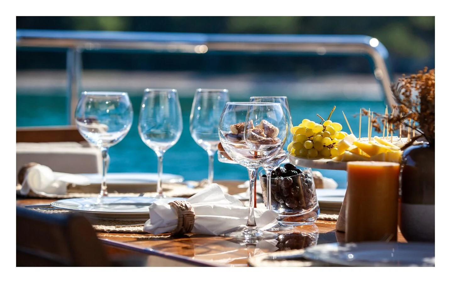 a table with wine glasses and food on it aboard BERING 70 RA Yacht for Sale
