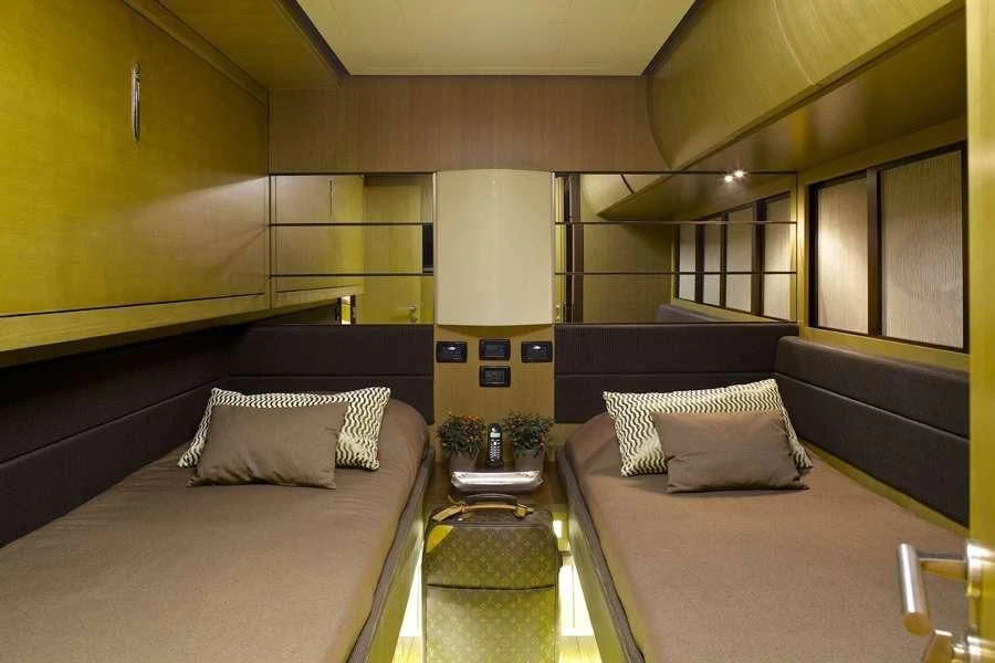 a room with a bed and a table aboard SOLARIS Yacht for Sale
