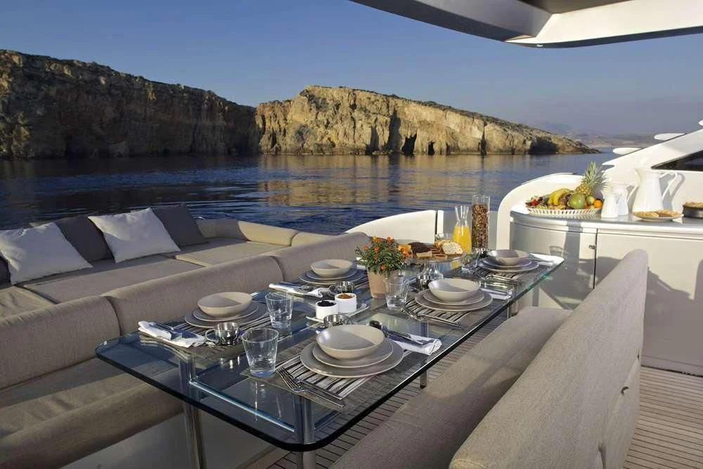 a table with plates and food on it aboard SOLARIS Yacht for Sale