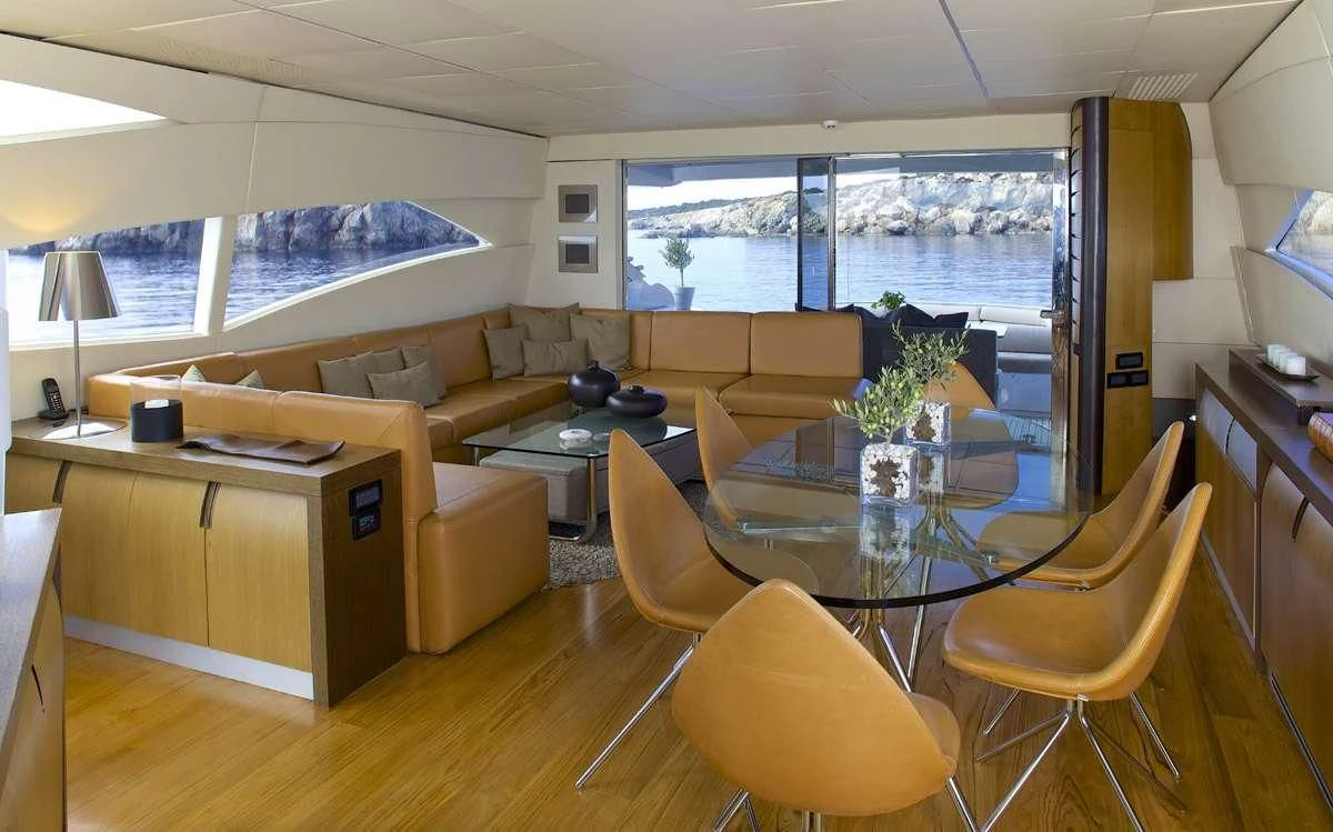 a living room with a table and chairs aboard SOLARIS Yacht for Sale