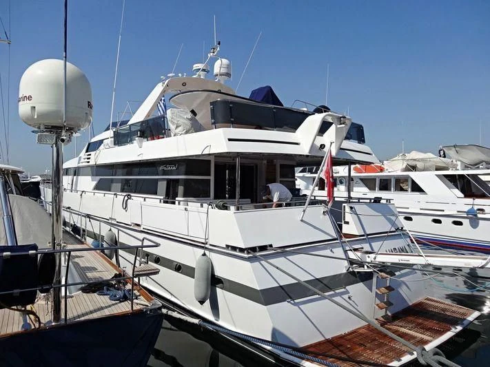 a large white boat sits in a harbor aboard HARAMA II Yacht for Sale