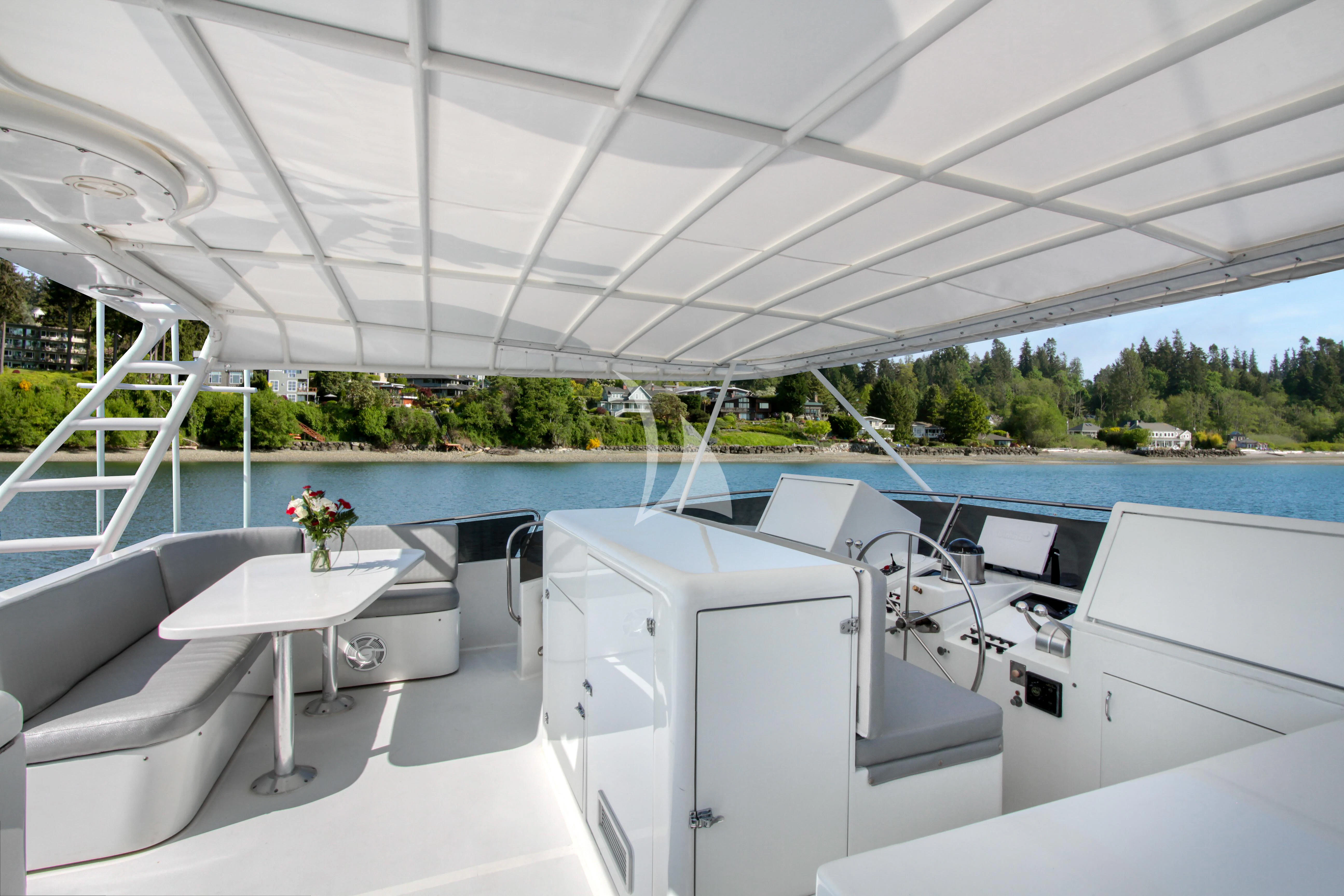 a room with a table and chairs aboard FIRST HOME Yacht for Sale