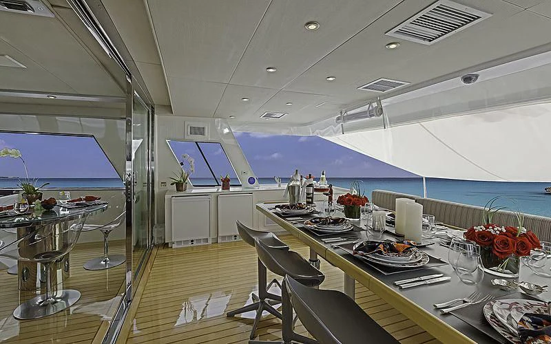 a large room with tables and chairs aboard FIRST HOME Yacht for Sale