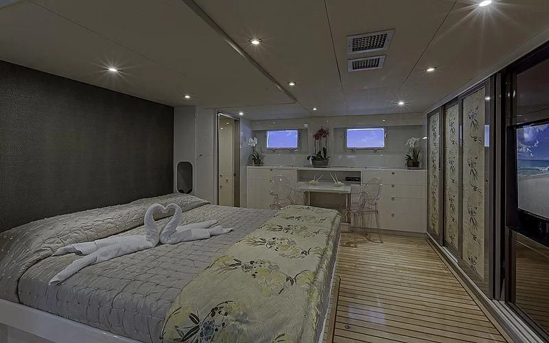 a bedroom with a bed and a tv aboard FIRST HOME Yacht for Sale