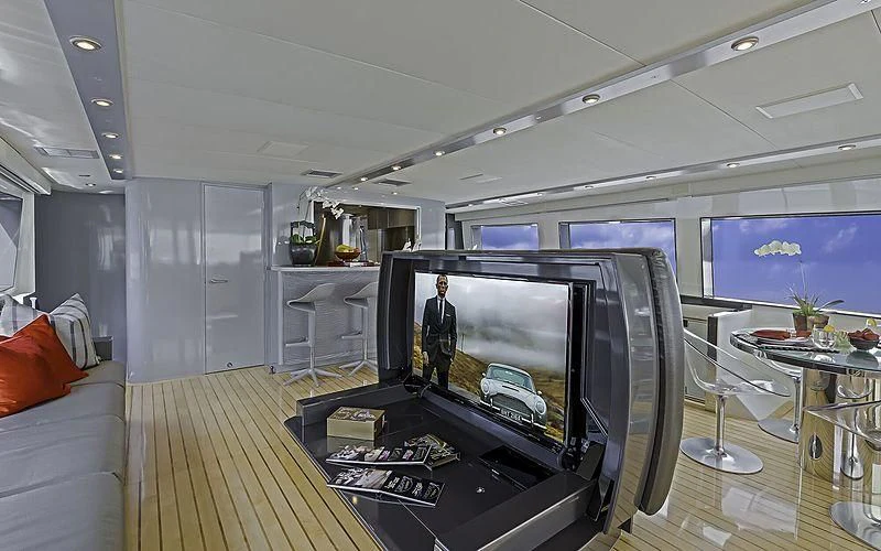 a room with a tv and a table aboard FIRST HOME Yacht for Sale