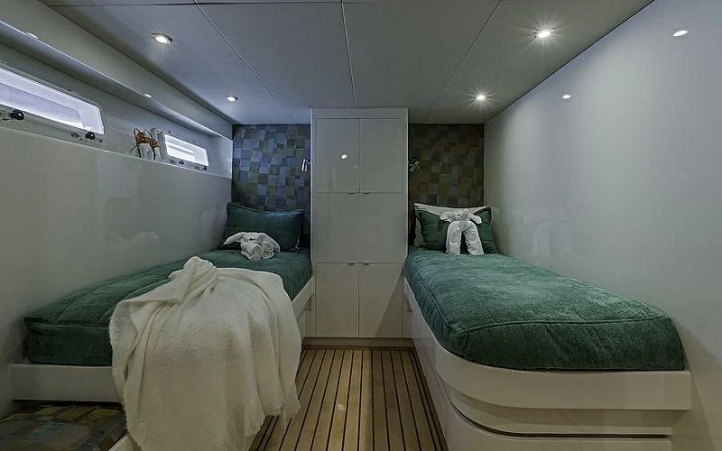 a room with beds and a door aboard FIRST HOME Yacht for Sale