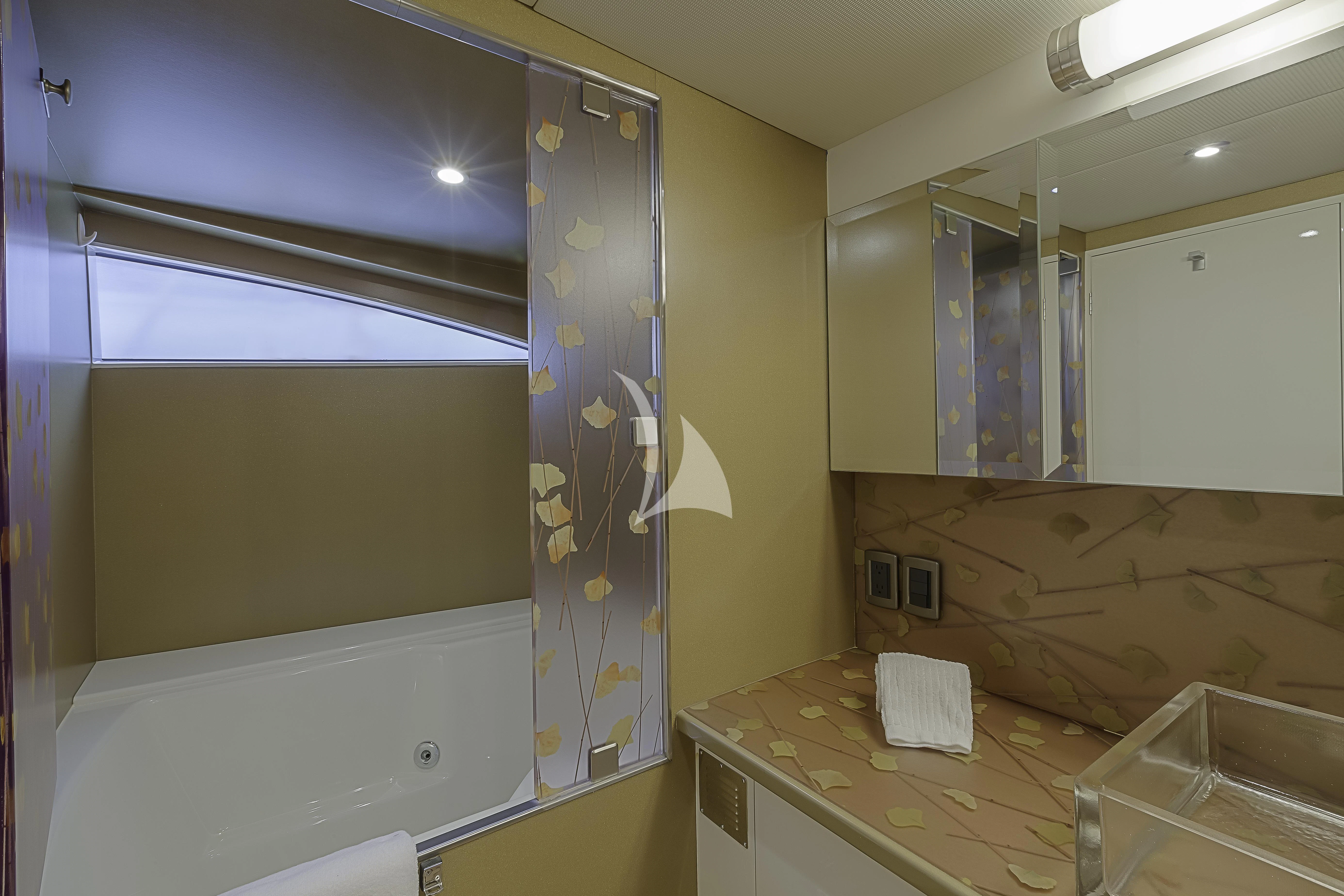 a bathroom with a tub and sink aboard FIRST HOME Yacht for Sale