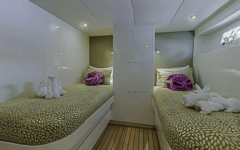 a room with two beds aboard FIRST HOME Yacht for Sale