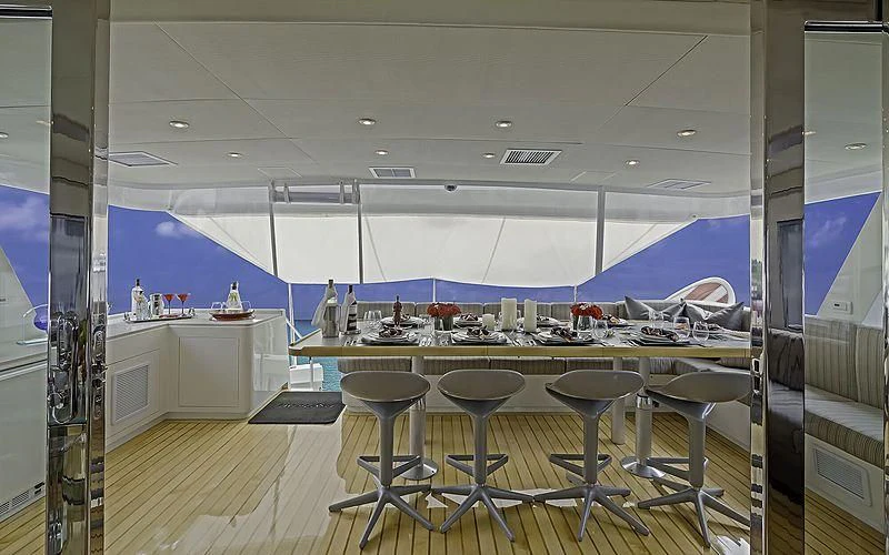 a room with tables and chairs aboard FIRST HOME Yacht for Sale