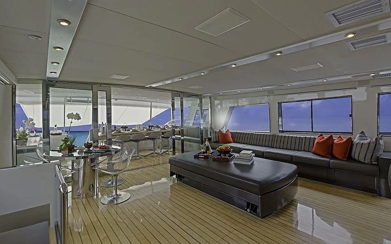 a large room with a couch and a table aboard FIRST HOME Yacht for Sale