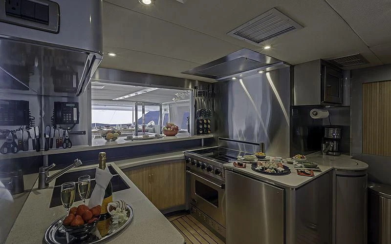 a kitchen with a large island aboard FIRST HOME Yacht for Sale