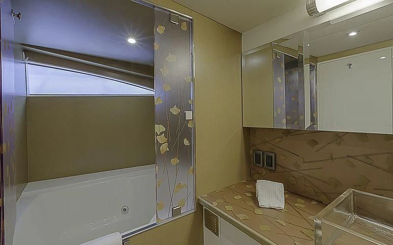 a bathroom with a tub and sink aboard FIRST HOME Yacht for Sale