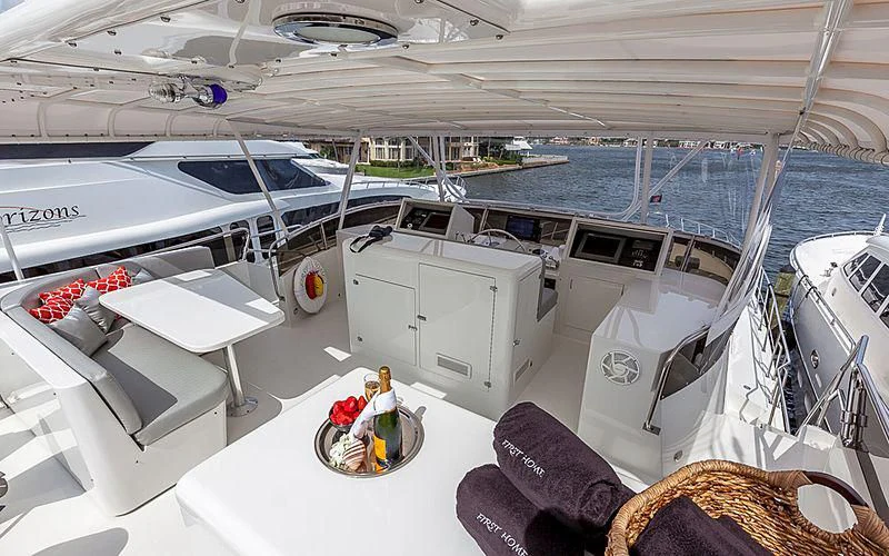 a boat with a table and chairs aboard FIRST HOME Yacht for Sale