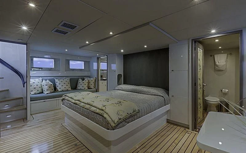 a bedroom with a bed and a mirror aboard FIRST HOME Yacht for Sale