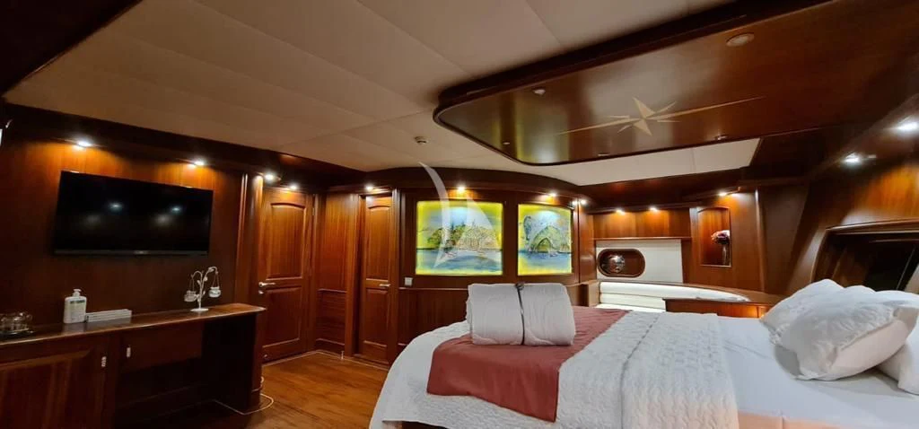 a room with a bed and a television aboard HALCON DEL MAR Yacht for Sale