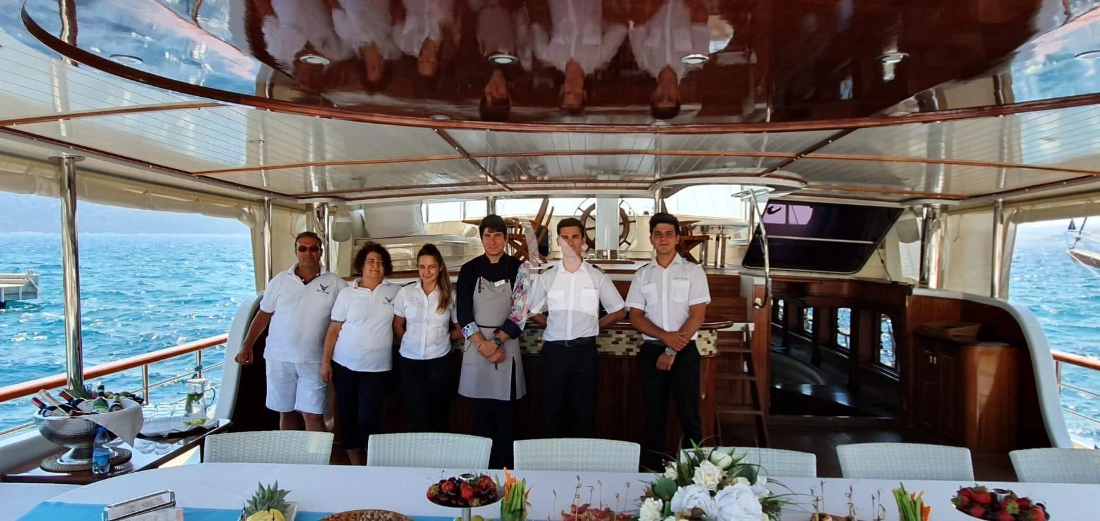 a group of people posing for a photo aboard HALCON DEL MAR Yacht for Sale