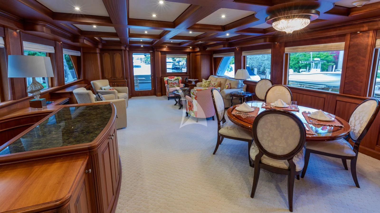 a large living room with a dining table and chairs aboard ANNDRIANNA Yacht for Sale