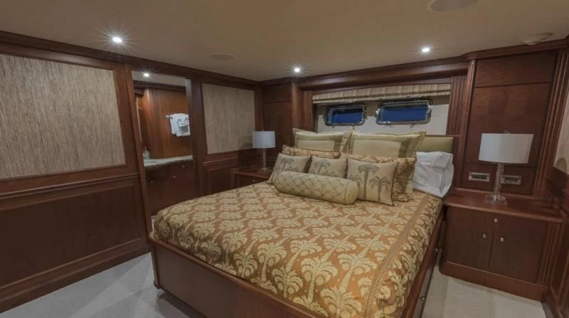 a bedroom with a bed and a desk aboard ANNDRIANNA Yacht for Sale