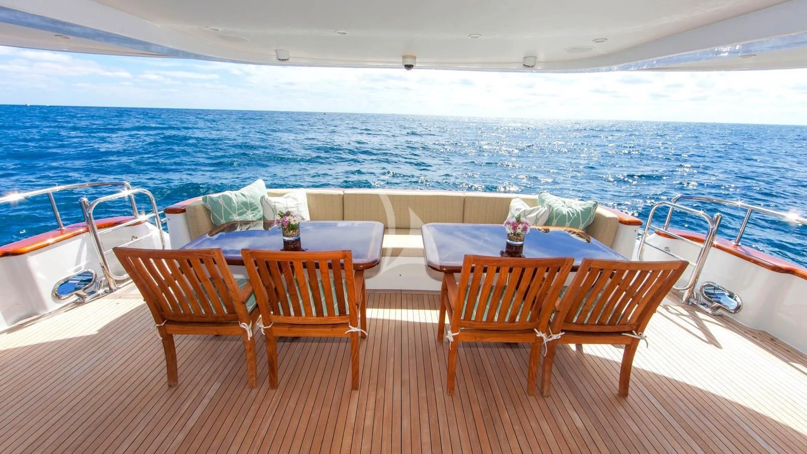a group of chairs on a deck overlooking a beach aboard ANNDRIANNA Yacht for Sale