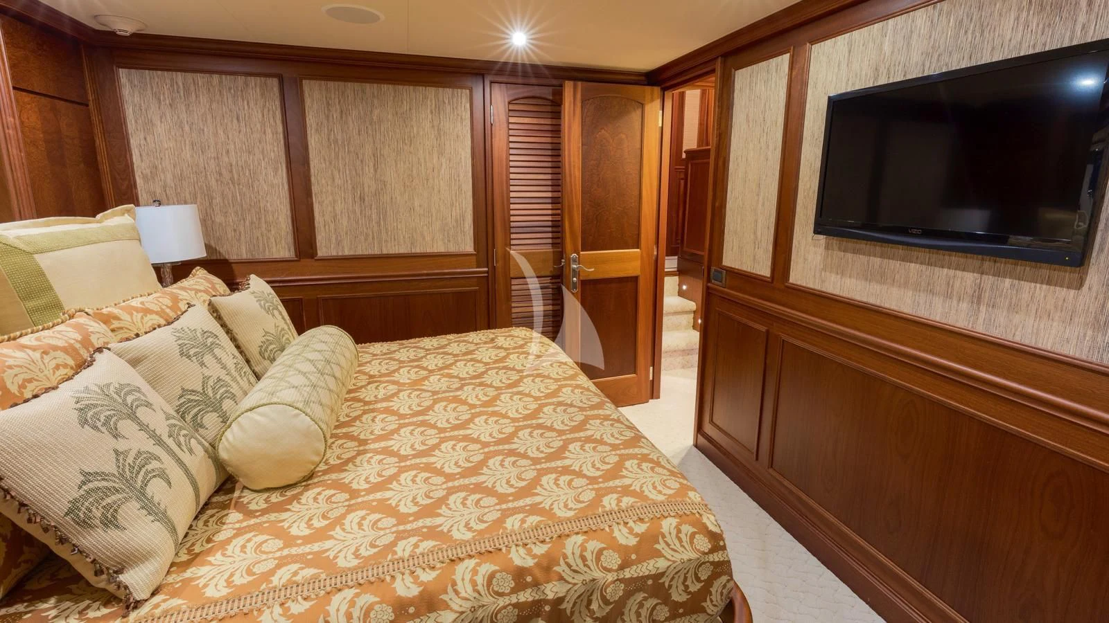 a bedroom with a bed and a television aboard ANNDRIANNA Yacht for Sale