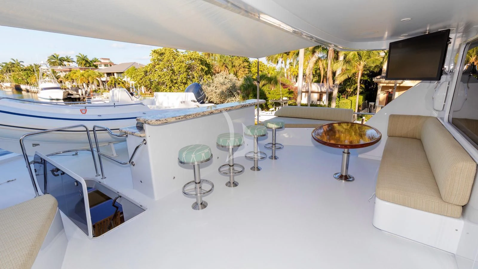 a table with chairs and a couch aboard ANNDRIANNA Yacht for Sale
