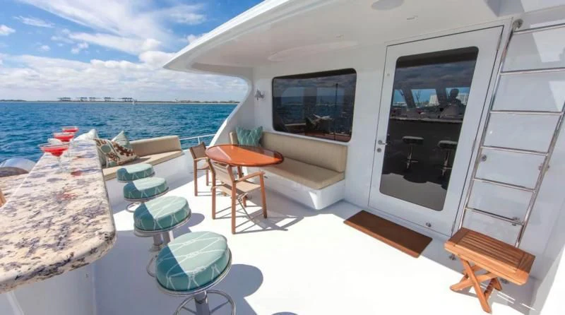 a room with a bed and a table and chairs aboard ANNDRIANNA Yacht for Sale