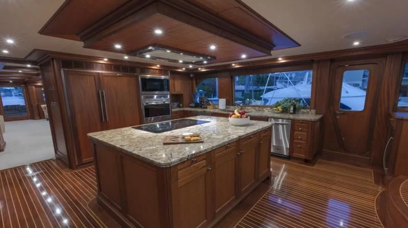 a kitchen with wooden cabinets aboard ANNDRIANNA Yacht for Sale